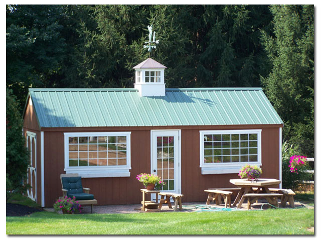 ellsworth cupola with golfer weathervane on a shed