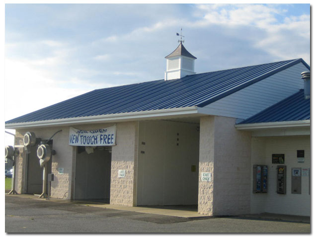 square cupola with arrow weathervane on car wash building