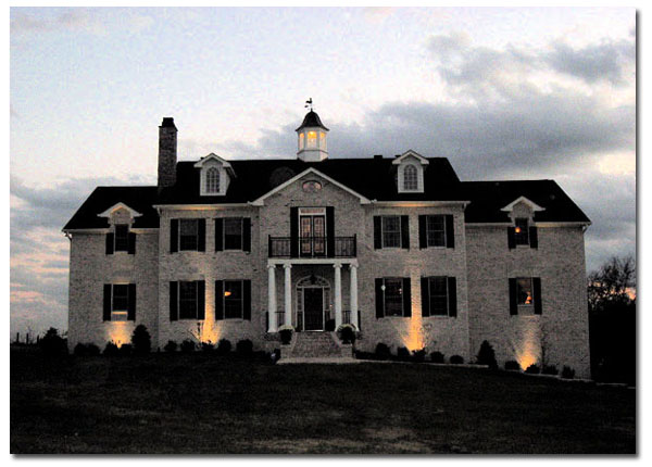 paddock cupola with windows and rooster on a large brick house front view