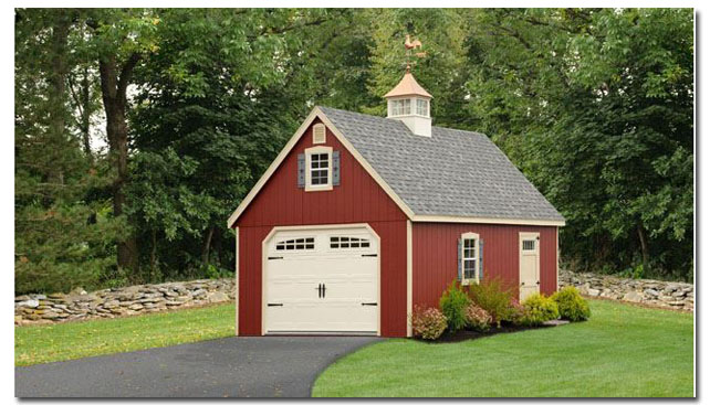 cupola with rooster weathervane on a red barn garage